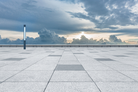 empty tiled floor against cloudy skyの写真素材