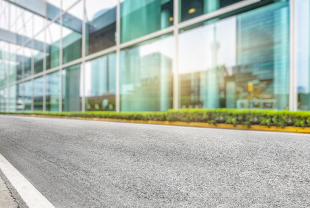 asphalt road near glass office buildingのeditorial素材