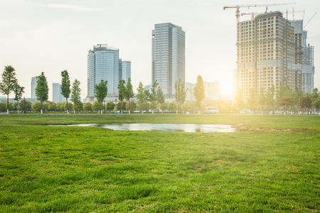 modern skyscrapers with green trees against blue sky ,shanghai,china.のeditorial素材