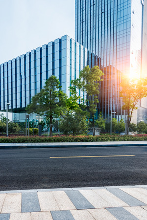 clean asphalt road through office block area,suzhou,china.のeditorial素材