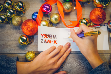 writing a greeting card for Christmas.の写真素材