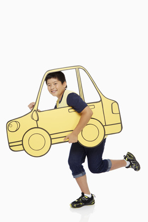 Boy looking out a cardboard car window, の写真素材