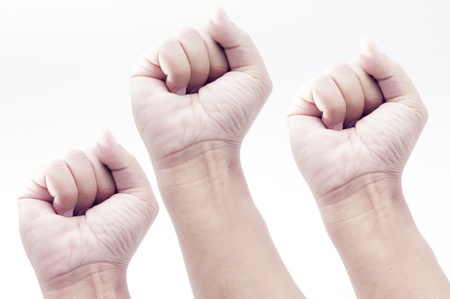 three Hands showing victory with a fist,isolated on whiteの写真素材