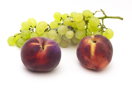 grape and peach on a white bacgroundの写真素材