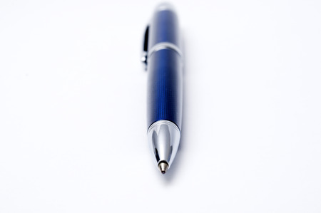 Close-up of a pen lying on a white  background 