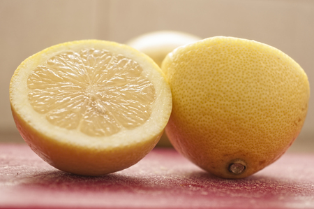 fresh ripe lemons on red backgroundの写真素材