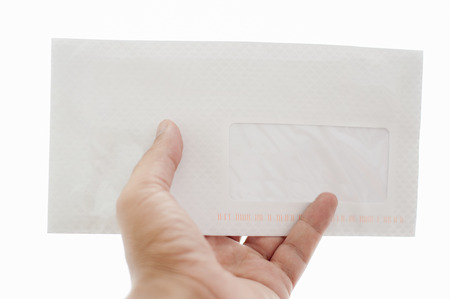 Hand passing letter isolated on whiteの写真素材