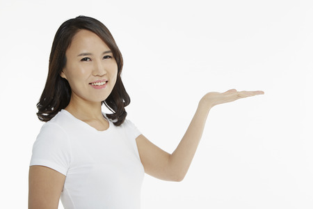 Woman smiling and showing hand gestureの写真素材