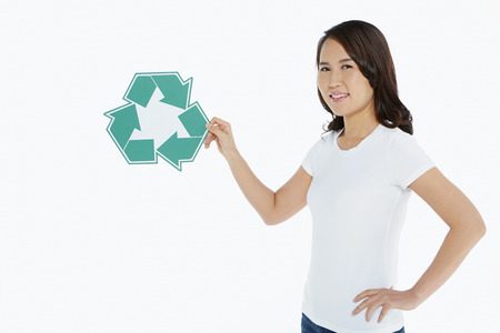 Woman holding up a Recycle" logo"の写真素材