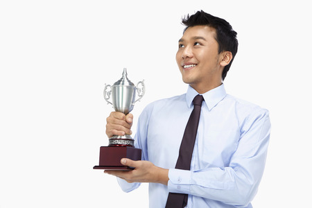 Businessman with a trophyの写真素材