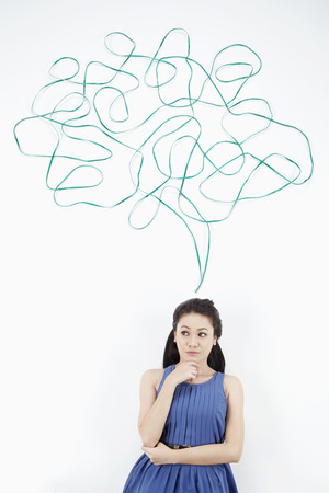 Woman with thought bubble against white backgroundの写真素材