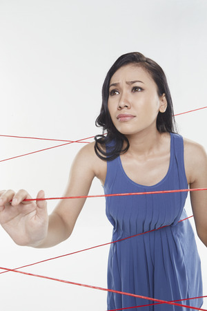 Woman trapped in between tangled wiresの写真素材
