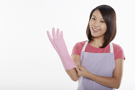 Woman putting on rubber glovesの写真素材