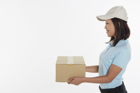 Delivery person carrying a cardboard box