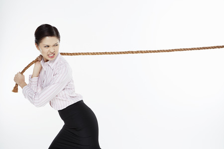 Businesswoman pulling a tightropeの写真素材