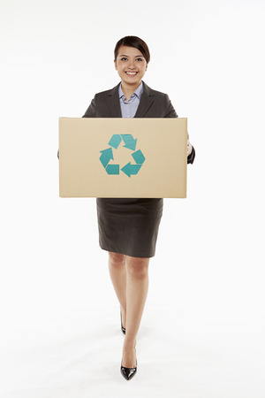 Businesswoman holding a recyclable cardboard boxの写真素材