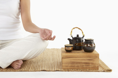 Woman sitting and meditatingの写真素材