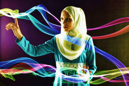 Woman gesturing against abstract backgroundの写真素材