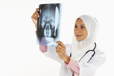 Medical personnel examining an x-ray filmの写真素材