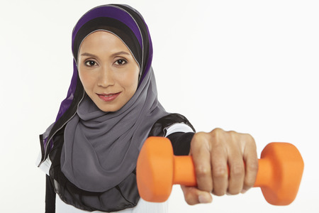 Woman holding out a dumbbellの写真素材