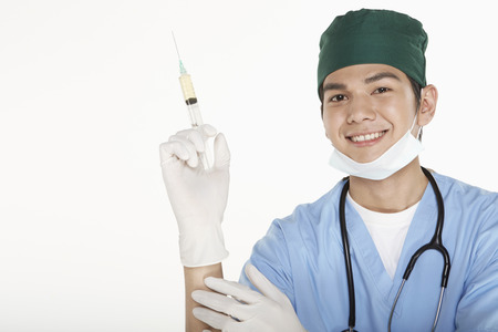 Medical personnel holding up a syringeの写真素材