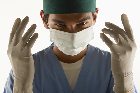 Medical personnel holding up his hands, with a scary expressionの写真素材