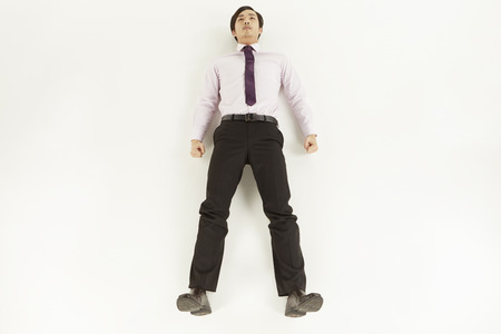 Businessman laying still on the floorの写真素材