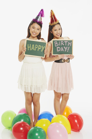 Women holding up a Happy Birthday" sign"の写真素材
