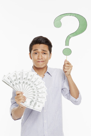 Man holding a pile of cashの写真素材