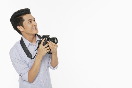 Man taking pictures with a digital cameraの写真素材