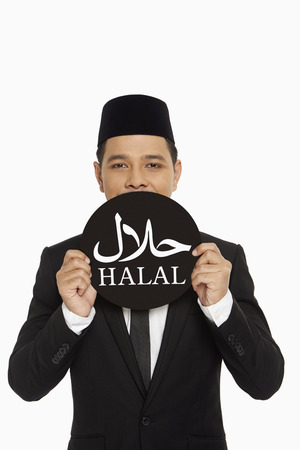 Businessman holding up a Halal" sign"の写真素材
