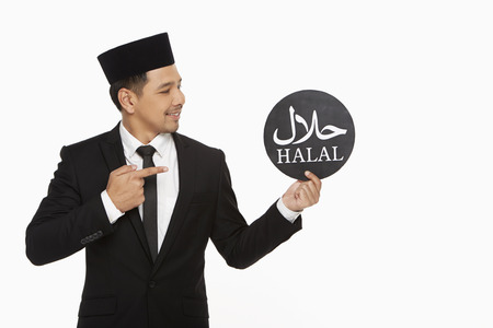 Businessman holding up a Halal" sign"の写真素材