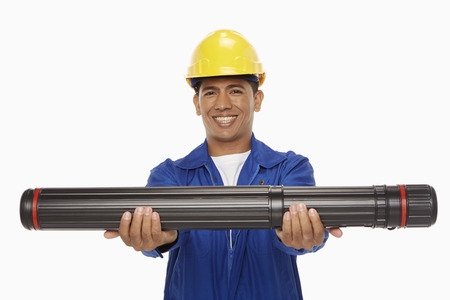 Construction worker holding up a blueprint plan 