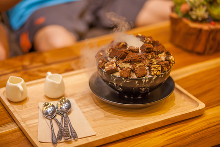 Brown ice cream In a brown cup on blur backgroundの写真素材