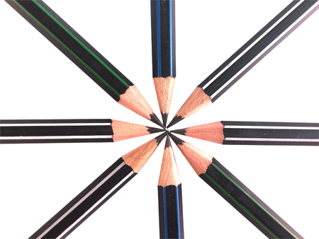 Several dark colored pencils on white background.の写真素材