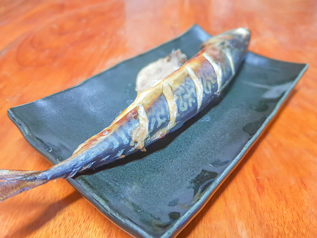 selective focus of Grilled Saba fish sauce in a black square on the tableの写真素材