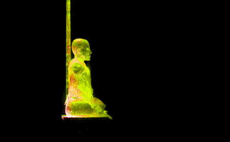The picture is dark and blurred of  light yellow, second from bottom of the Buddha statue created from translucent resin.の写真素材