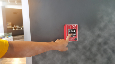 Fire alarm buttons are pressed while the fire is possible and there is a lot of smoke.の写真素材