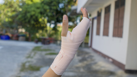 Hurt hand wrapped in bandage.
