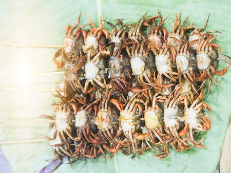 Fried crab in the dish. Lay on the table with a banana leaf.の写真素材