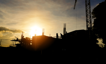 silhouette picture of construction workers were working in the morning sun light beautifully.の写真素材