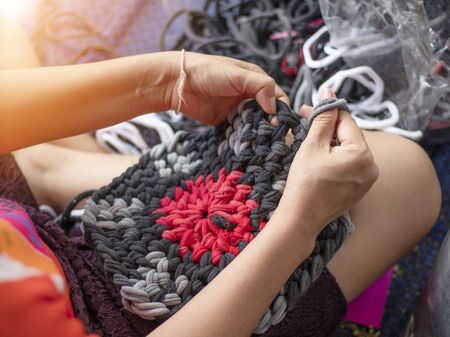 On selective focus of middle-aged women A braided mat with a rag to find extra income for the family.の写真素材