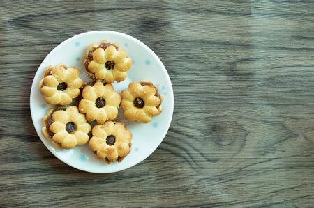 Sweets and sweet green water and prepared for a light meal on the floor with wooden boards.の写真素材