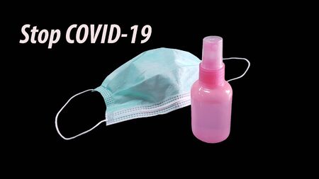 Masks and alcohol. To prevent virus COVID-19 on a black background.の写真素材