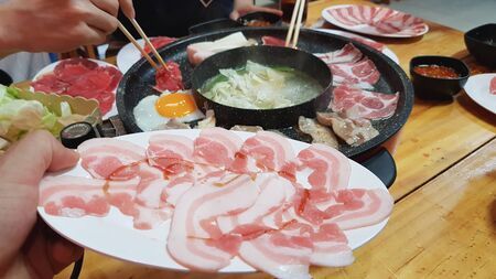 On selective  focus of beef grilled food For socializing with family. Slides into thin sheets, grilled on an electric stove.の写真素材