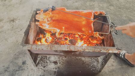 The whole pork is sloping with a grilled sod on the stove.の写真素材