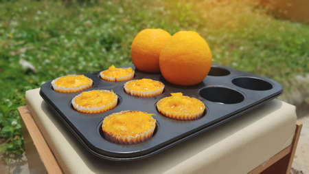 On selective focus of orange flavored cake in In black  mold for making  dessert. Handmade cake Of the home cook.の写真素材