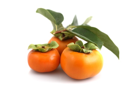 Organic persimmons in a group on white backgroundの写真素材
