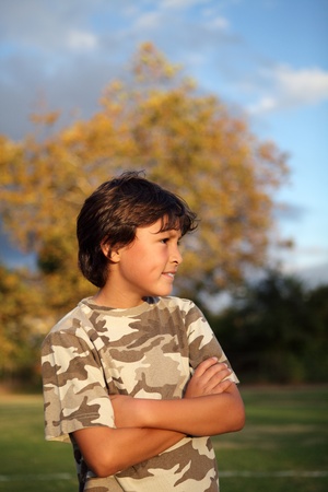 Happy smiling boy in the park near to sunset with shallow depth of field and copy space at topの写真素材