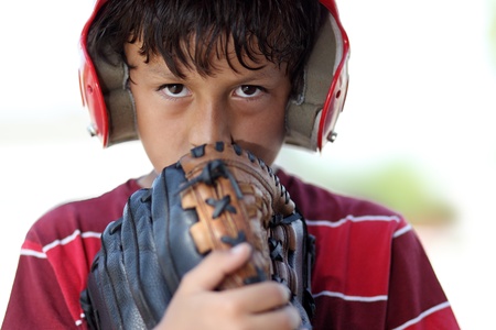Young serious baseball boy with red helmetの写真素材